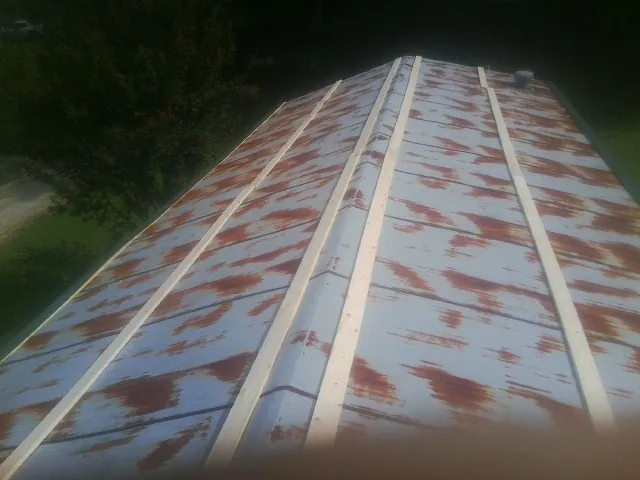 Rusted metal roof panels with new wood purlins before replacement — Storm Damage Roof Repair in Yucaipa by Roofing Brothers