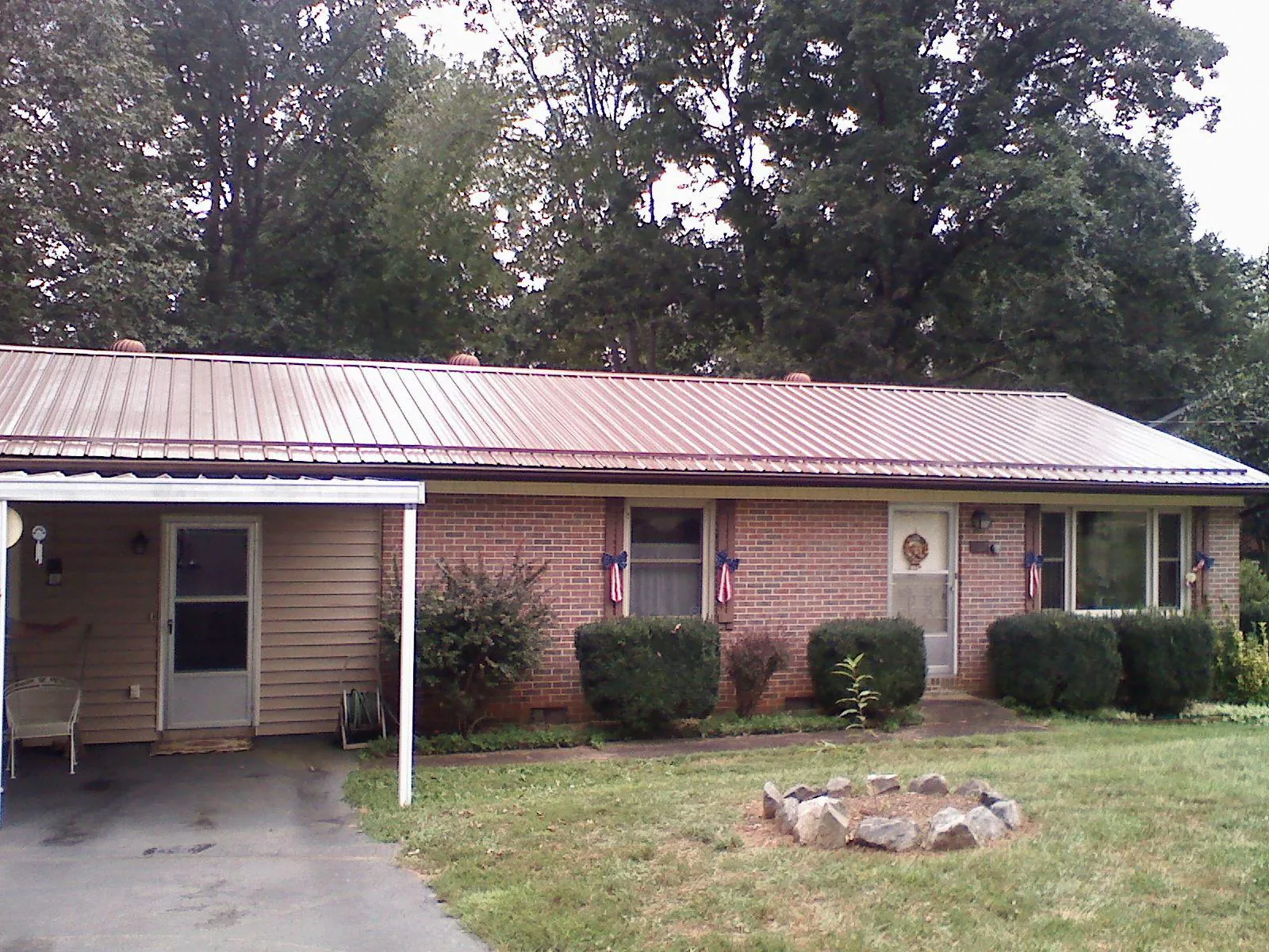 Bronze metal roof and carport on a brick ranch home — Roof Repair work by our crew in Yucaipa